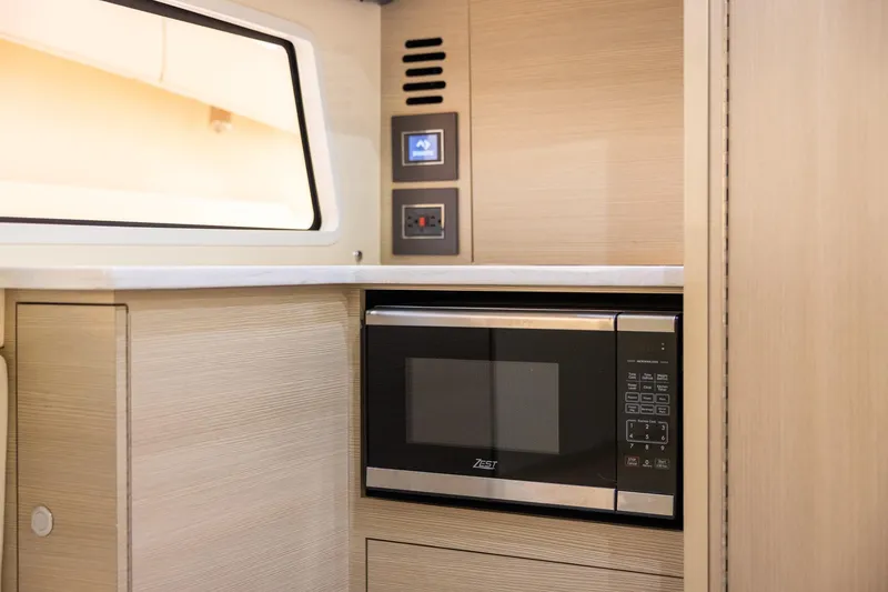 Slide: The Image of 2024 Scout 377 LXF interior with microwave and modern cabinetry. - 44