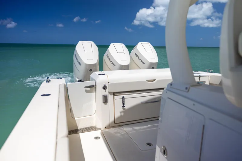 Slide: The Image of 2024 Scout 377 LXF boat with triple Mercury engines on open sea. - 51