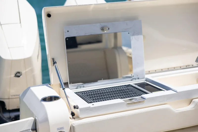 Slide: The Image of 2024 Scout 377 LXF boat grill station with open lid, showcasing sleek design. - 56