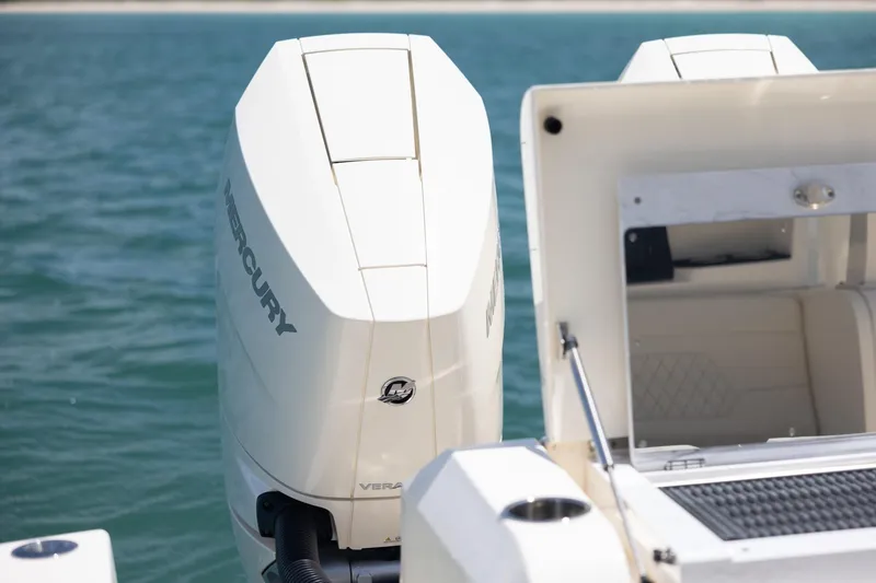 Slide: The Image of 2024 Scout 377 LXF boat with Mercury outboard engine on calm water. - 57