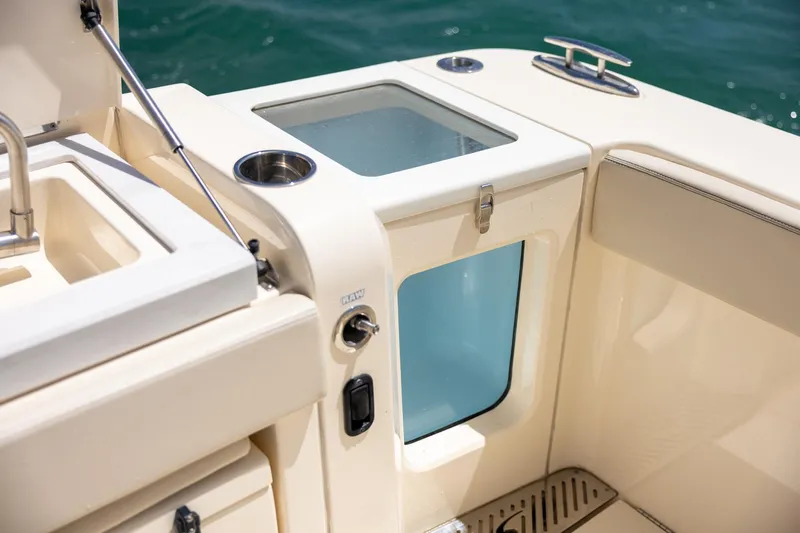 Slide: The Image of 2024 Scout 377 LXF boat interior with sink and storage compartment. - 61
