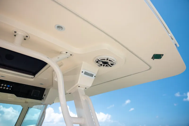 Slide: The Image of 2024 Scout 377 LXF boat roof with speaker and blue sky background. - 63