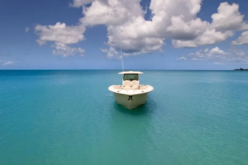 Slide: The Image of 2024 Scout 377 LXF boat on tranquil turquoise sea under cloudy sky. - 9