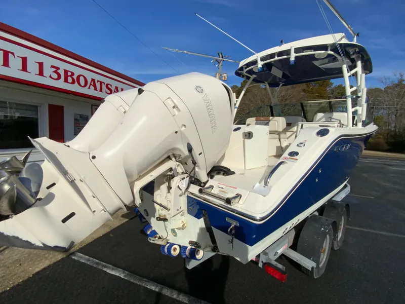 Slide: The Image of 2019 Cobia 280 Dual Console boat with Yamaha outboard, parked on a trailer. - 10