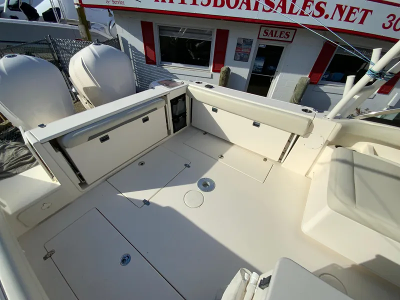 Slide: The Image of 2019 Cobia 280 Dual Console boat deck with storage compartments and seating. - 14