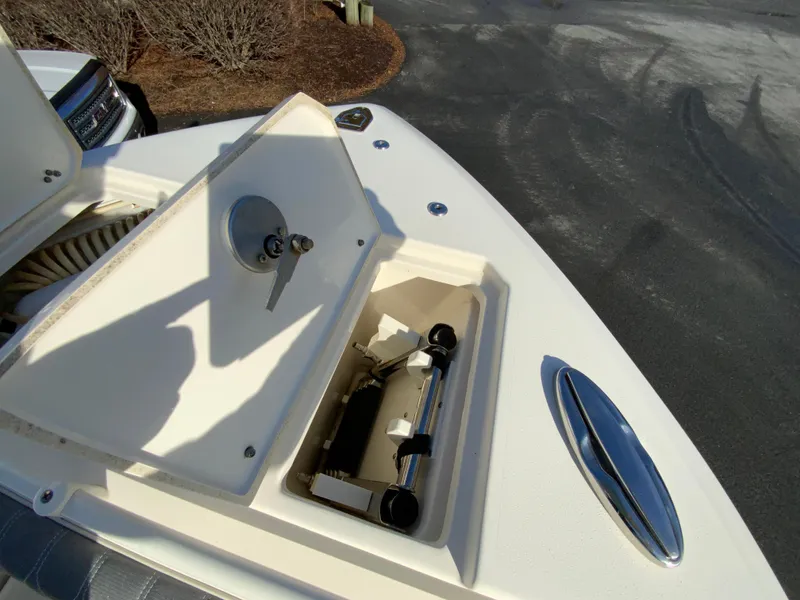 Slide: The Image of 2019 Cobia 280 Dual Console boat storage compartment with open hatch and equipment inside. - 23