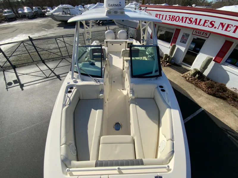 Slide: The Image of 2019 Cobia 280 Dual Console boat with spacious seating, displayed at a boat sales lot. - 25