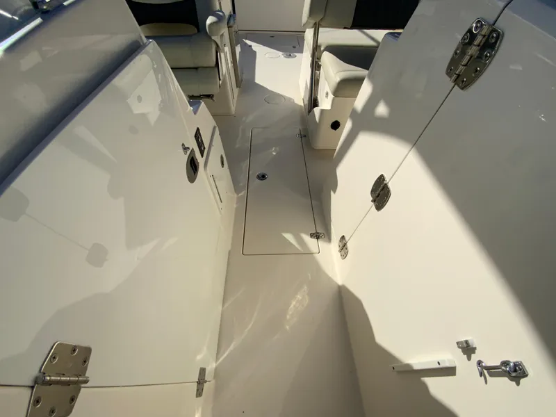 Slide: The Image of 2019 Cobia 280 Dual Console boat interior with seating and storage compartments. - 27