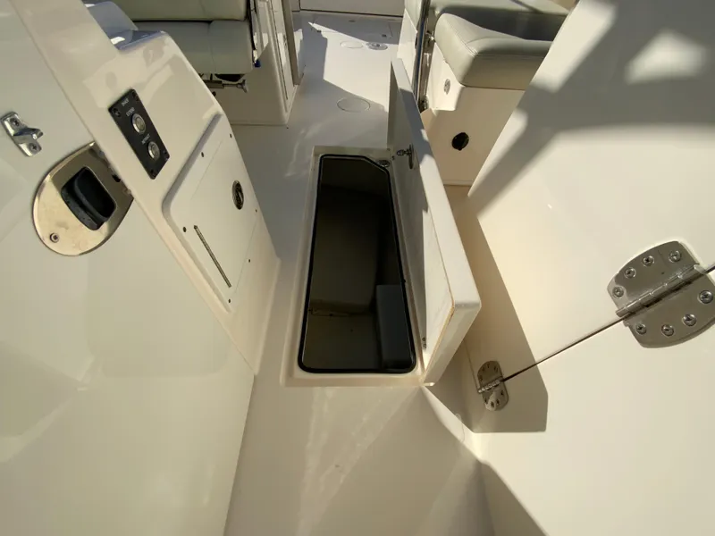 Slide: The Image of 2019 Cobia 280 Dual Console boat interior with open storage compartment. - 28