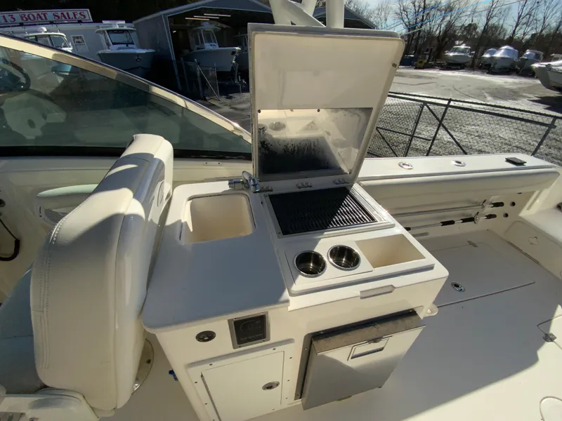 Slide: The Image of 2019 Cobia 280 Dual Console boat with outdoor kitchen and seating area. - 32