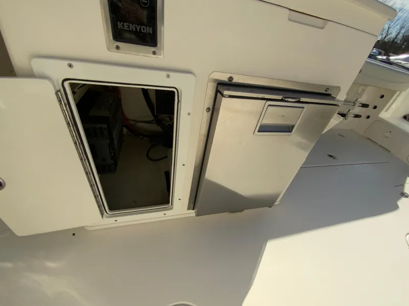 Slide: The Image of 2019 Cobia 280 Dual Console interior with storage and Kenyon equipment. - 33