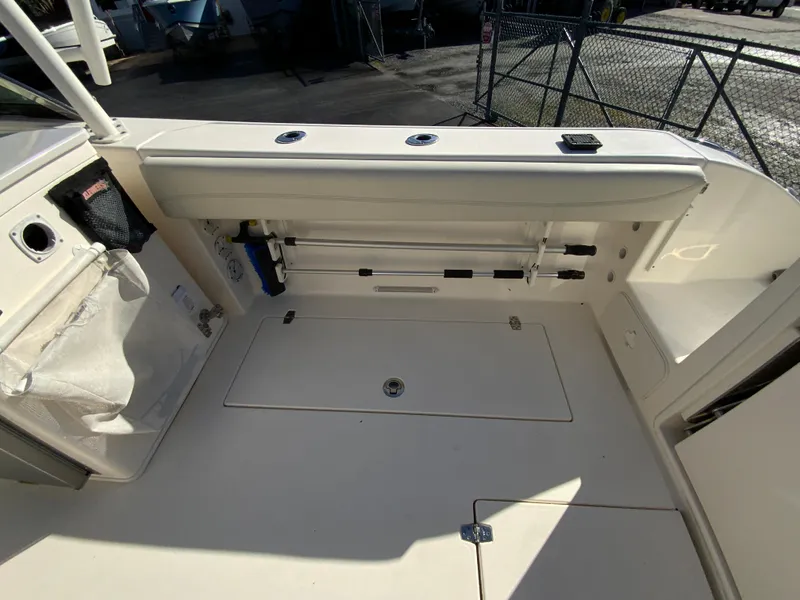 Slide: The Image of 2019 Cobia 280 Dual Console boat interior with storage compartments and seating area. - 35