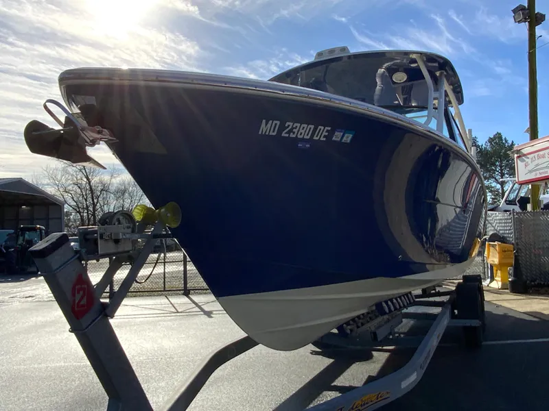 Slide: The Image of 2019 Cobia 280 Dual Console boat on trailer, sunny day, side view. - 4