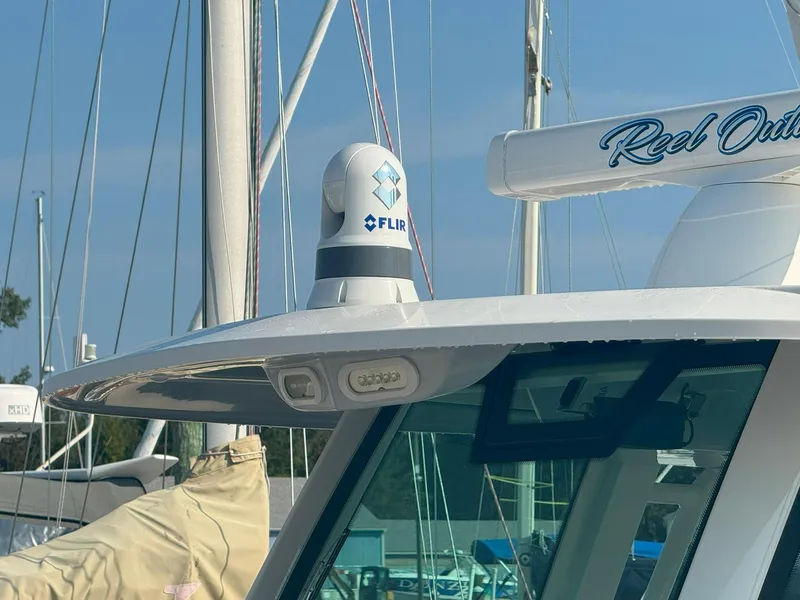Slide: The Image of 2019 Sailfish 360 CC boat with FLIR camera on deck, docked at marina. - 13