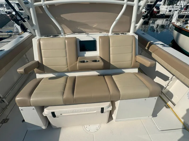 Slide: The Image of 2019 Sailfish 360 CC boat seating area with beige cushions and armrests. - 16