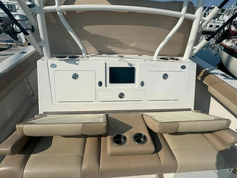 Slide: The Image of 2019 Sailfish 360 CC boat interior with beige seating and storage compartments. - 17