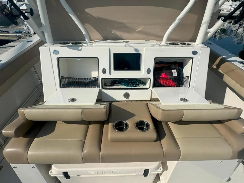 Slide: The Image of 2019 Sailfish 360 CC boat interior with storage compartments and seating. - 18