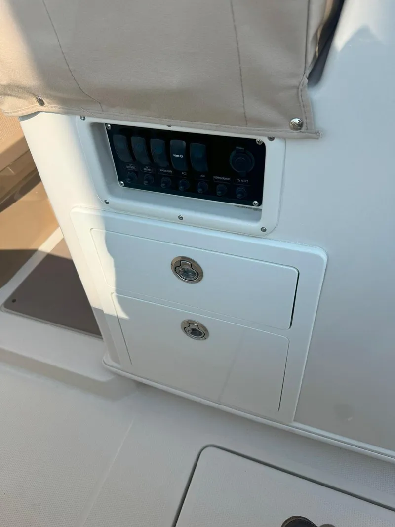 Slide: The Image of Control panel and storage on 2019 Sailfish 360 CC boat. - 20
