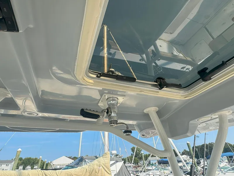 Slide: The Image of 2019 Sailfish 360 CC boat roof detail with hatch and marina background. - 23