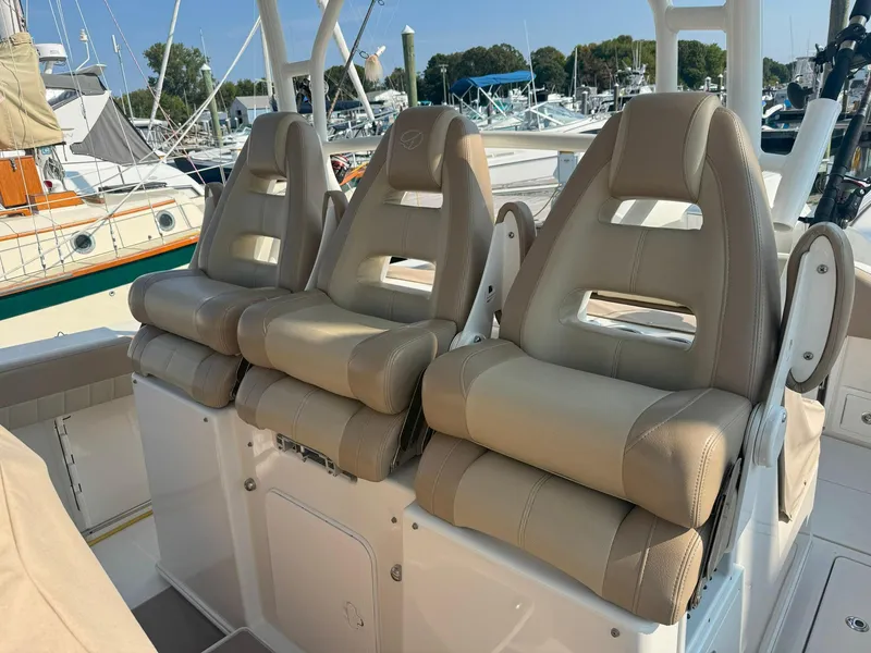 Slide: The Image of Three beige captain's chairs on a 2019 Sailfish 360 CC boat. - 25