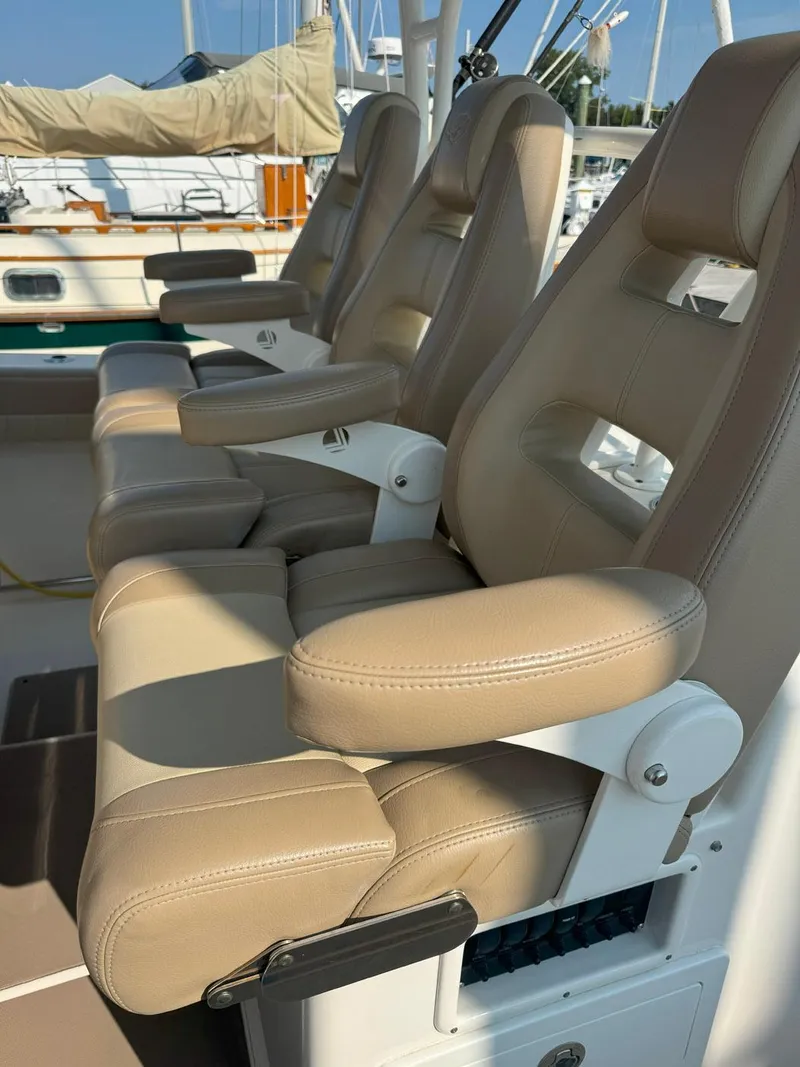 Slide: The Image of 2019 Sailfish 360 CC boat with beige leather seats, docked at a marina. - 27