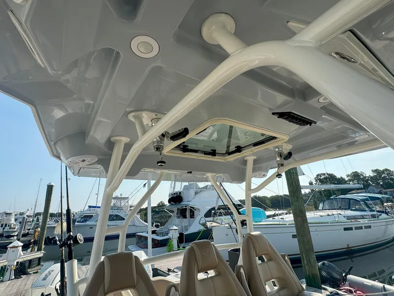 Slide: The Image of 2019 Sailfish 360 CC boat interior with seating and overhead view at marina. - 28