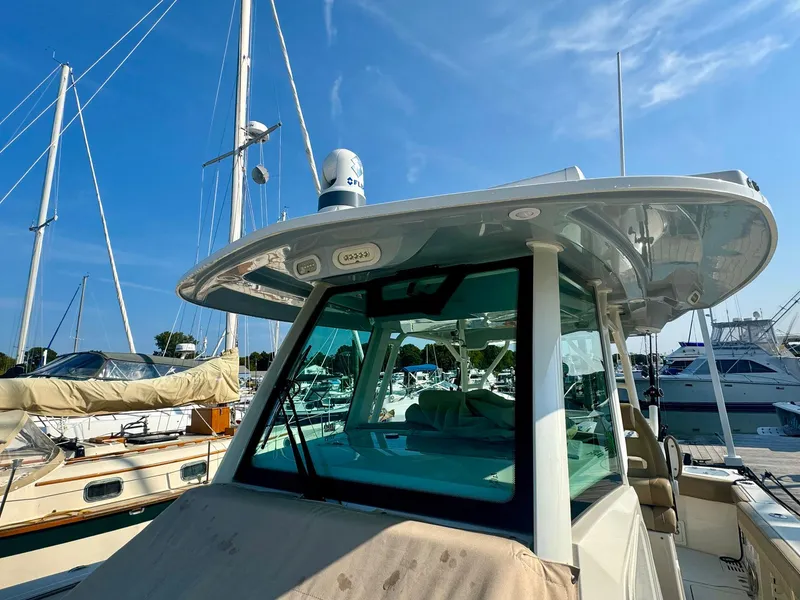 Slide: The Image of 2019 Sailfish 360 CC boat docked at marina under clear blue sky. - 29