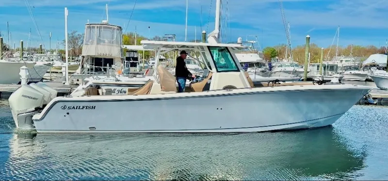Slide: The Image of 2019 Sailfish 360 CC boat docked in a marina, clear sky background. - 3