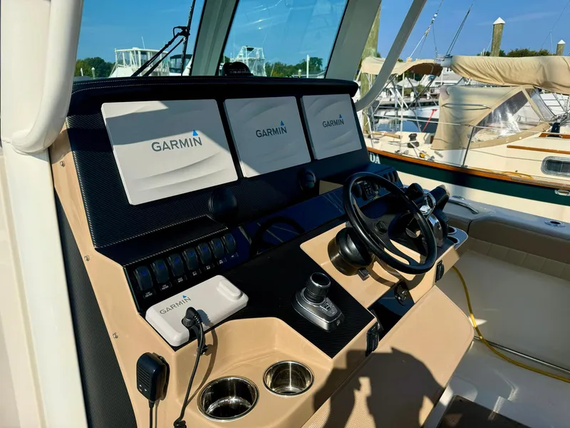 Slide: The Image of 2019 Sailfish 360 CC boat dashboard with Garmin navigation displays. - 31
