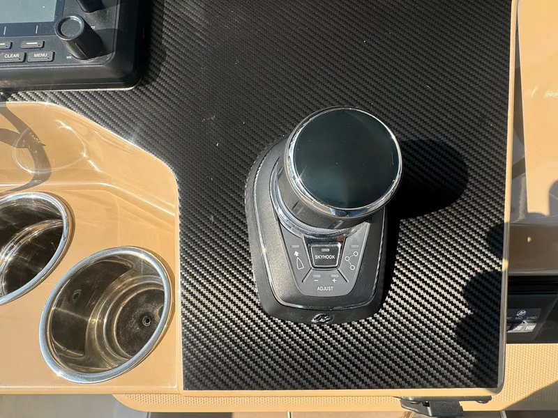 Slide: The Image of 2019 Sailfish 360 CC boat control panel with joystick and cup holders. - 37