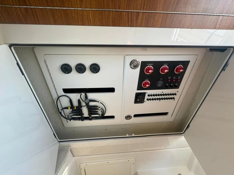 Slide: The Image of Control panel of 2019 Sailfish 360 CC boat, featuring switches and wiring. - 38