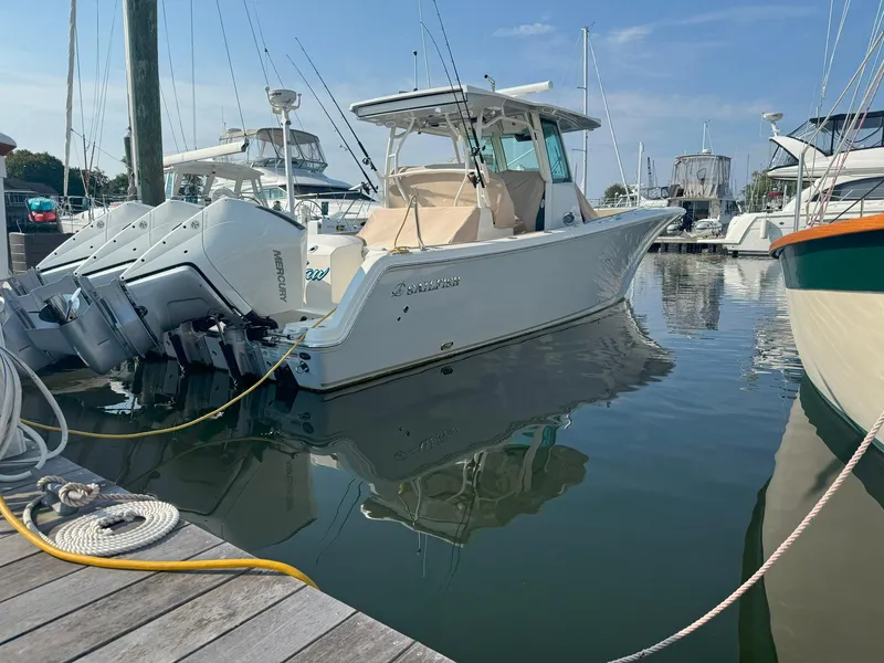 Slide: The Image of 2019 Sailfish 360 CC boat docked in marina with twin engines. - 4