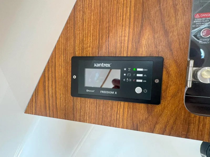 Slide: The Image of Xantrex Freedom X control panel on 2019 Sailfish 360 CC boat interior. - 40
