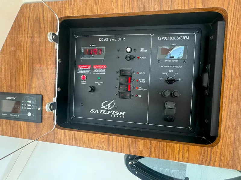 Slide: The Image of Control panel of 2019 Sailfish 360 CC boat with voltage display and switches. - 41