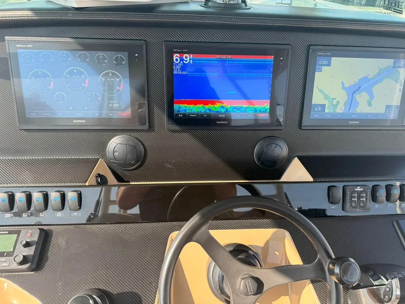 Slide: The Image of Dashboard of 2019 Sailfish 360 CC with navigation and control screens. - 42