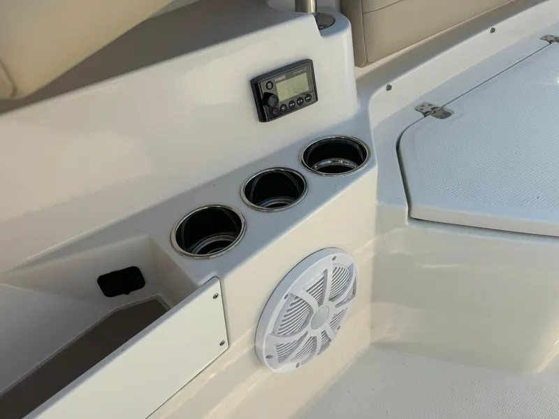 Slide: The Image of 2019 Sailfish 360 CC boat interior with cup holders and speaker. - 43