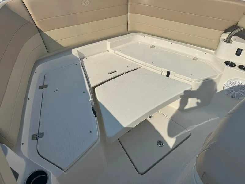 Slide: The Image of 2019 Sailfish 360 CC boat interior with beige seating and storage compartments. - 44