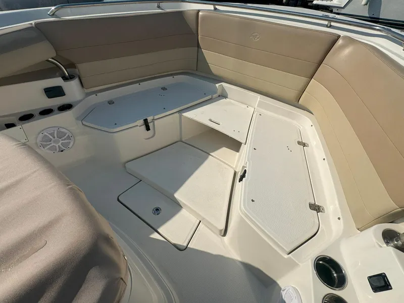 Slide: The Image of 2019 Sailfish 360 CC boat interior with beige seating and storage compartments. - 45