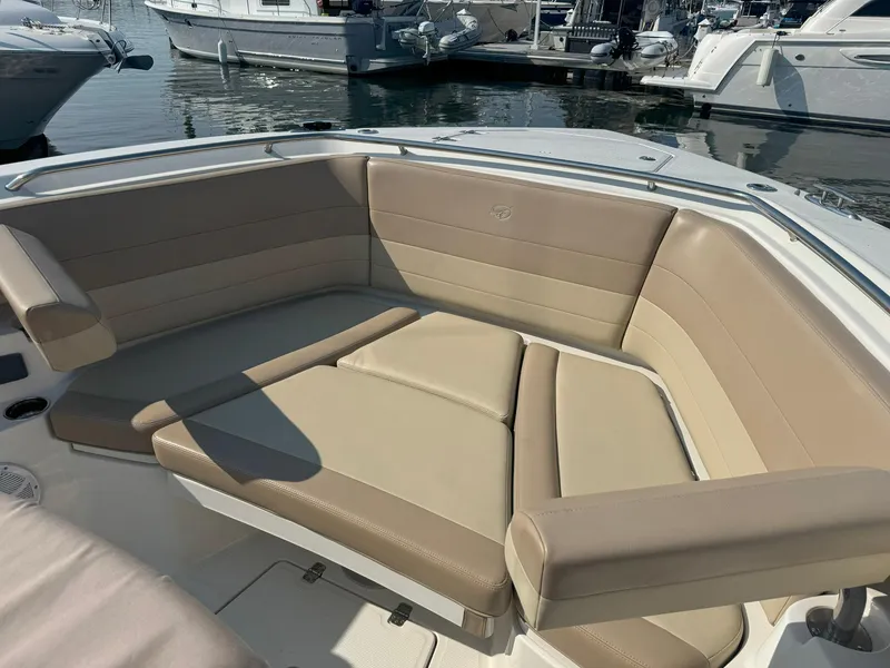 Slide: The Image of 2019 Sailfish 360 CC boat with beige seating at a marina. - 49