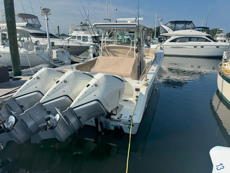 Slide: The Image of 2019 Sailfish 360 CC boat docked with triple outboard engines. - 6