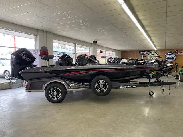 The Image of 2023 Ranger Z518 boat in showroom, side view, on trailer. - 1