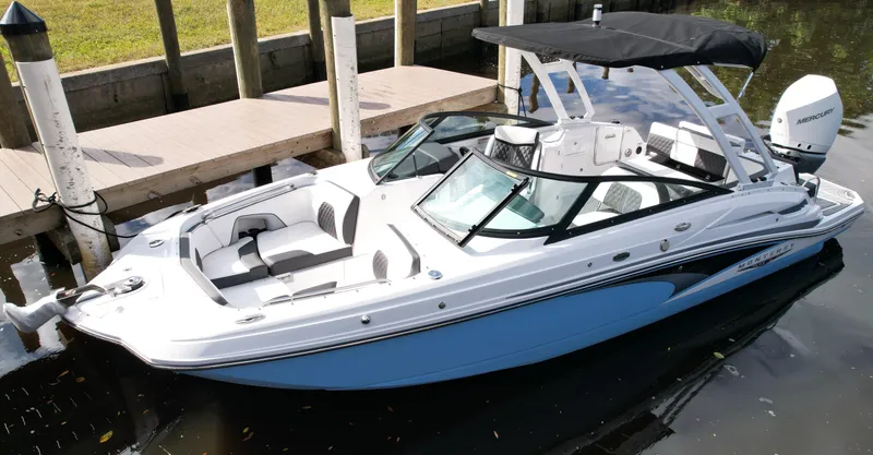 Slide: The Image of 2025 Monterey M45 boat with Mercury engine, docked on calm water. - 2