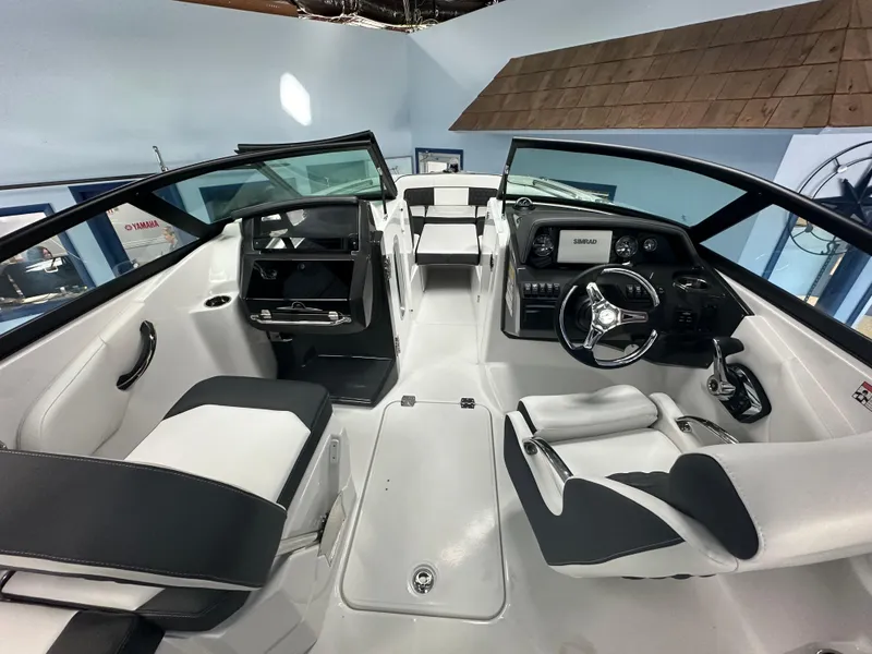 Slide: The Image of 2025 Monterey M45 boat interior with sleek white and black seating, modern dashboard, and spacious layout. - 24