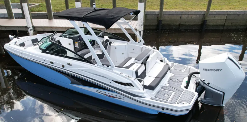 Slide: The Image of 2025 Monterey M45 boat with Mercury engine, docked on calm water. - 3