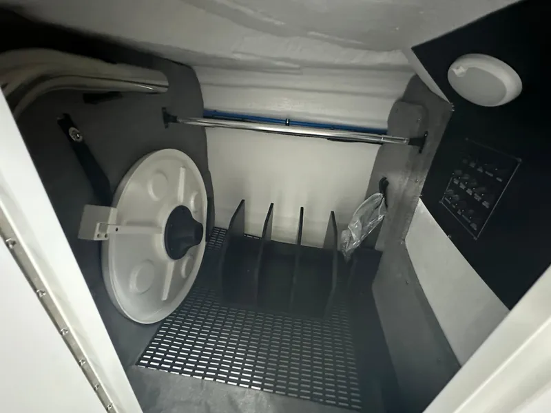 Slide: The Image of 2025 Monterey M45 boat interior with white and black seating in showroom. - 33