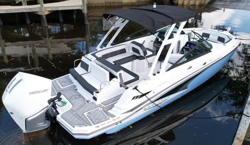 Slide: The Image of Boat docked in a serene canal with palm trees and blue sky, featuring a 2025 Monterey M45. - 4