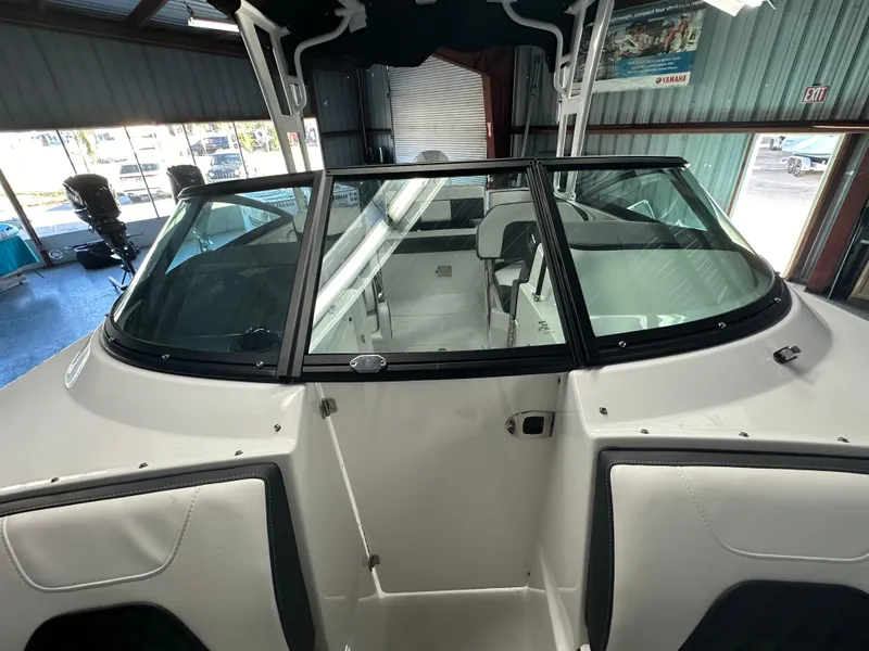 Slide: The Image of 2025 Monterey M45 boat in a covered storage facility, showcasing sleek design and windshield. - 44