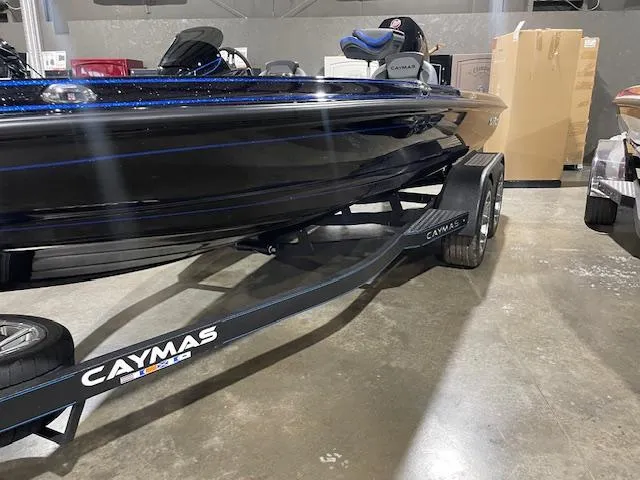 Slide: The Image of 2025 Caymas CX 20 boat on trailer in showroom. - 10