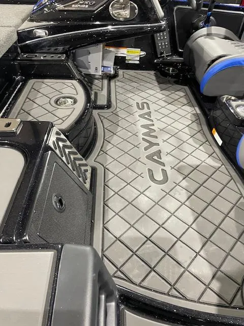Slide: The Image of 2025 Caymas CX 20 boat interior with branded flooring and seating. - 11