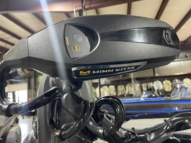 Slide: The Image of Minn Kota motor on 2025 Caymas CX 20 boat in a showroom setting. - 9